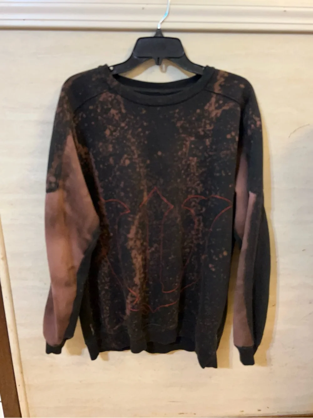 A upcycled, custom bleach-splattered Adidas crewneck sweatshirt